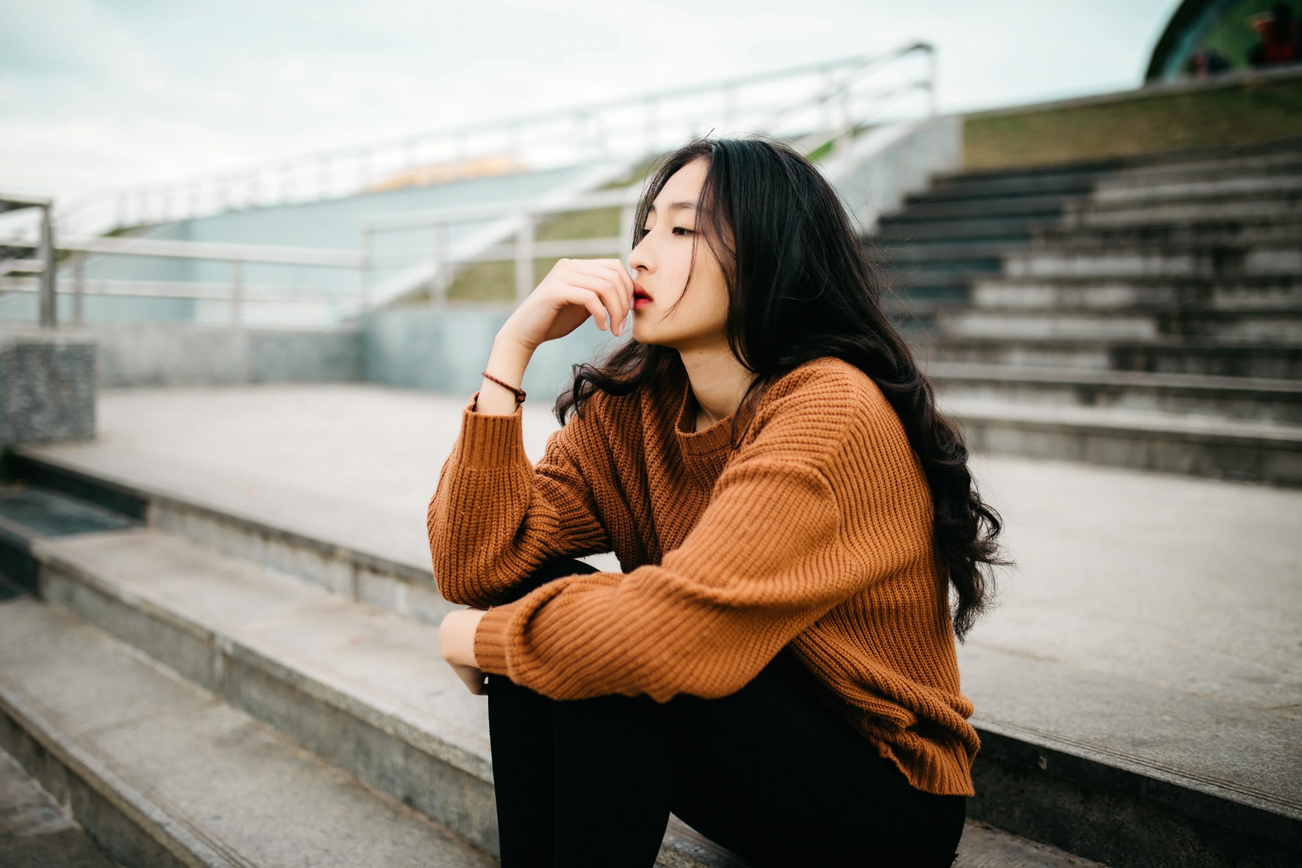 Woman sitting down thinking about making a decision. Do you struggle with making decisions?  